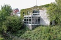 Old abandoned building overgrown plants, covered with plants