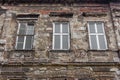 Old abandoned building with three windows. Aged brick wall. Vintage architecture concept. Ancient house. Royalty Free Stock Photo
