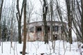 An old abandoned building in winter among the trees. Abandoned building Royalty Free Stock Photo