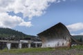 An old abandoned bulldozer dump against the background of abandoned warehouses in Siberia, as a symbol of the collapse of Royalty Free Stock Photo