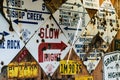 Old abandoned California road signs with bullet holes displayed on a wall