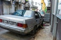 Old abandoned car in a city alley Royalty Free Stock Photo