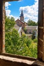 Old abandoned Catholic Church overgrown with greenery