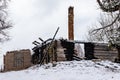An old abandoned charred building in snowy hill