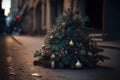 Abandoned christmas tree lying on the stree at night