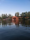 Old, abandoned, collapsed wooden house on the water on the river