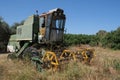 Old abandoned combine harvester in the field