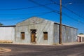 Old Abandoned Corner Building With Ornate Wrought Iron Window & Door Grates