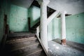 Old abandoned creepy manor house room. Stairs to the second floor. Royalty Free Stock Photo