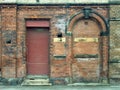 Old abandoned derelict industrial premises with bricked up door