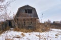 An old, abandoned, dilapidated wooden house on a winter day. Royalty Free Stock Photo