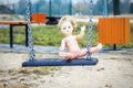 Old abandoned doll on a swing Royalty Free Stock Photo