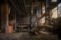 Old abandoned factory with pipes and cogs on a grungy floor Royalty Free Stock Photo