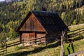 An old, abandoned farmhouse in a mountain meadow above the Carpathians. Beautiful walking landscape in Ukraine. autumn time Royalty Free Stock Photo