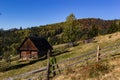 An old, abandoned farmhouse in a mountain meadow above the Carpathians. Beautiful walking landscape in Ukraine. autumn time Royalty Free Stock Photo