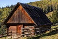 An old, abandoned farmhouse in a mountain meadow above the Carpathians. Beautiful walking landscape in Ukraine. autumn time Royalty Free Stock Photo