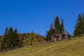 An old, abandoned farmhouse in a mountain meadow above the Carpathians. Beautiful walking landscape in Ukraine. autumn time Royalty Free Stock Photo