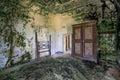 Old abandoned farmhouse with room ruined by green mold