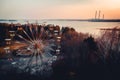 Old abandoned ferris wheel carousel in front of power plant chimneys. This abandoned park is in Elektrenai city in Lithuania, but Royalty Free Stock Photo