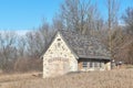 An old abandoned field stone building or house in a rural area in late autumn on a cloudy day Royalty Free Stock Photo