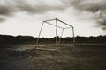 Old abandoned football goal post standing on field