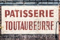 Old abandoned french bakery shop sign on a brick wall Royalty Free Stock Photo