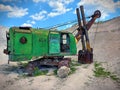 Old and abandoned green large excavator with heavy shovel in limestone quarry. Rusty technique. Sunny summer day with clear skies Royalty Free Stock Photo