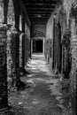 Old abandoned haunted house with fragile walls in parallel and sunlight coming through the walls. Monochrome shot Royalty Free Stock Photo