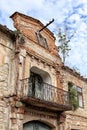 Old abandoned house frontage with balcony and falling gable Royalty Free Stock Photo