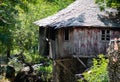 Old abandoned house in the countryside with broken roof and windows near a river Royalty Free Stock Photo