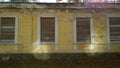 Old abandoned house in disrepair. Windows are filled with wooden planks instead of glass. Poverty, devastation, economic, financia Royalty Free Stock Photo