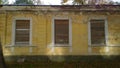 Old abandoned house in disrepair. Windows are filled with wooden planks instead of glass. Poverty, devastation, economic, financia Royalty Free Stock Photo