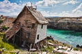 Old abandoned house on the edge of a cliff overlooking the sea with cliffs in the background Royalty Free Stock Photo