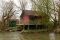 Old abandoned house elevated above river Royalty Free Stock Photo