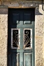 Old abandoned house facade with green wooden door