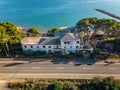 old abandoned house with pool on the beach overgrown with palm trees and plants, lost places, tarragona spain Royalty Free Stock Photo