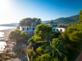 old abandoned house with pool on the beach overgrown with palm trees and plants, lost places, tarragona spain Royalty Free Stock Photo