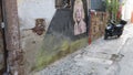 An old abandoned house. Stone wall and street art painting Marilyn Monroe.