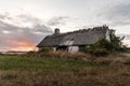 An old abandoned house with a thatched roof, solitary located overlooking the sea at Bisserup