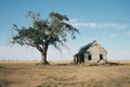 an old abandoned house and tree in the middle of nowhere Royalty Free Stock Photo