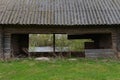 old abandoned log house in a green clearing near a pond Royalty Free Stock Photo