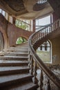 Old abandoned mansion with decorated spiral staircase Royalty Free Stock Photo