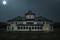 Old abandoned mansion in mystic spooky forest. Haunted house with dark atmosphere, full moon, bats and creepy details like in horr Royalty Free Stock Photo