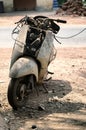 Old abandoned motorcycle with rusty components in the dust Royalty Free Stock Photo