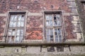 Old devastated wall of abandoned house with broken windows Royalty Free Stock Photo