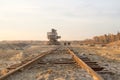 Old abandoned railway track. Rusty railroad tie. Giant stacker. Bucket chain excavator in a sand quarry. Bulk material handling