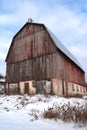 Old Abandoned Red Barn in Winter Landscape Royalty Free Stock Photo