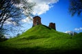 Ancient ruined castle fortress on a green hill Royalty Free Stock Photo