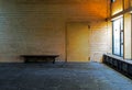 Old abandoned room with bench and a door Royalty Free Stock Photo