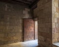 Old abandoned room with stone bricks and grunge weathered decorated door Royalty Free Stock Photo